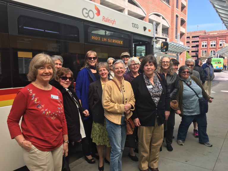 League of Women voters in front of bus