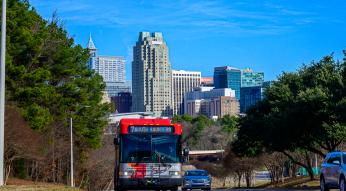 GoRaleigh bus departing downtown Raleigh with the skyline in the background