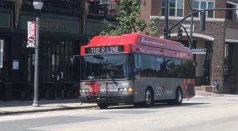Red and gray GoRaleigh bus with R-Line banner